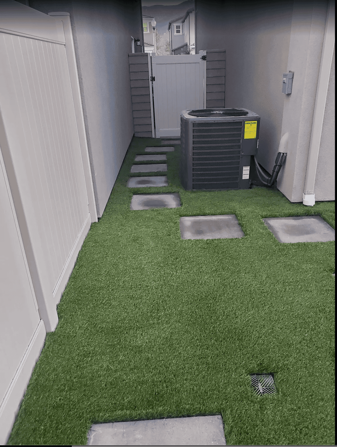 Artificial grass lawn installed by VC Turf with a clean edge along a paved border
