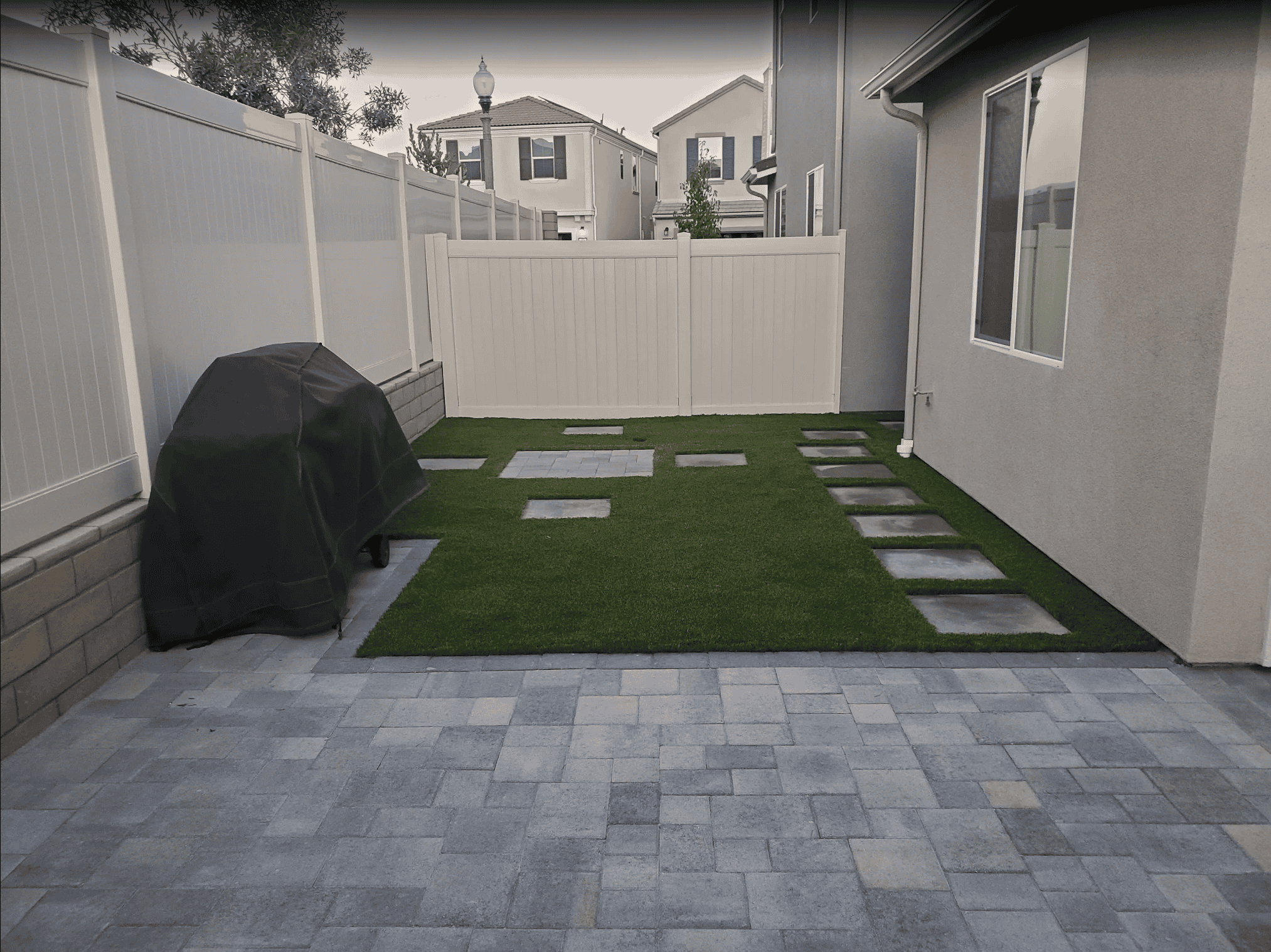 Artificial grass lawn edged with a paver border