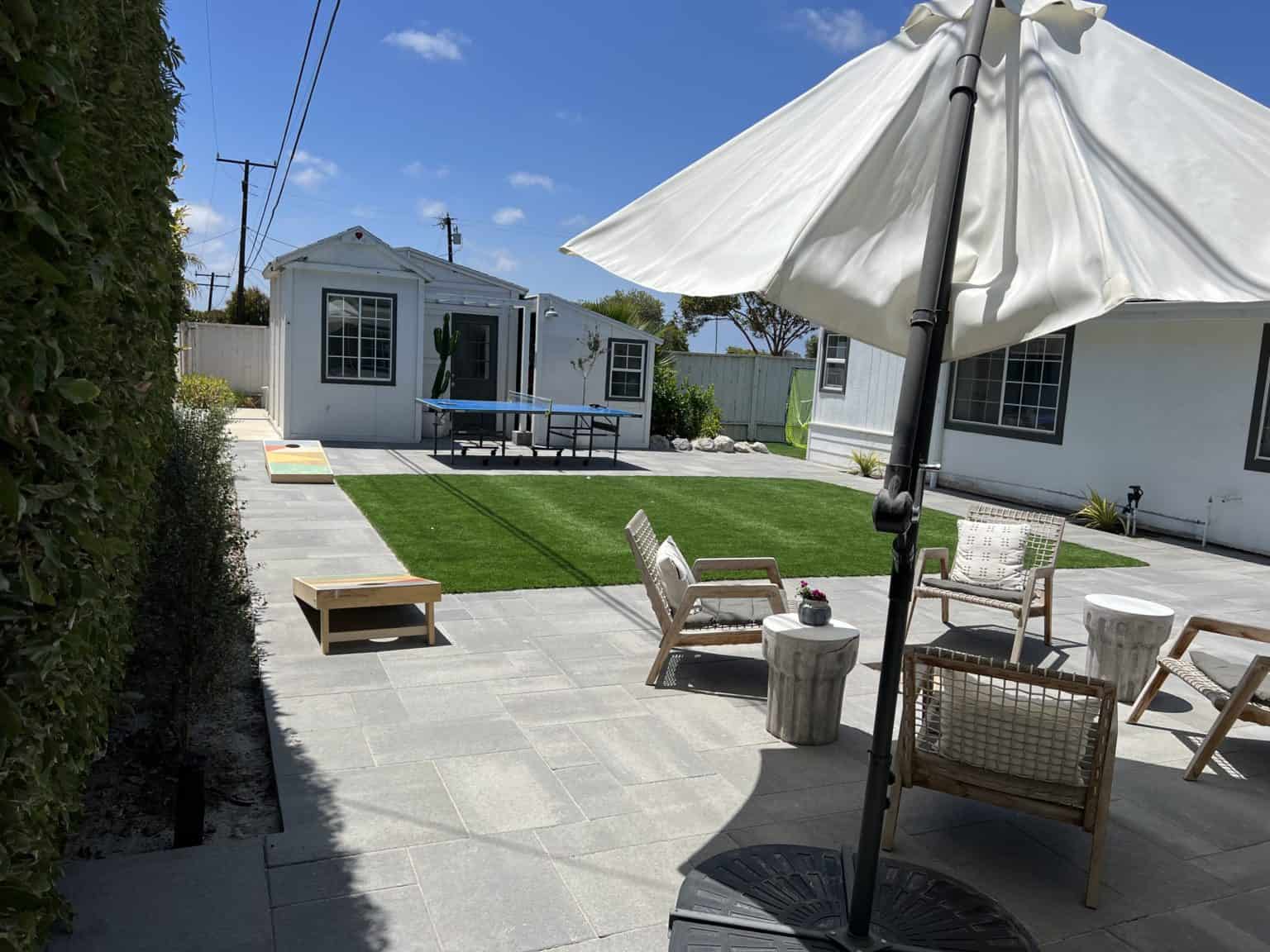 The same backyard after lawn removal with artificial turf installed