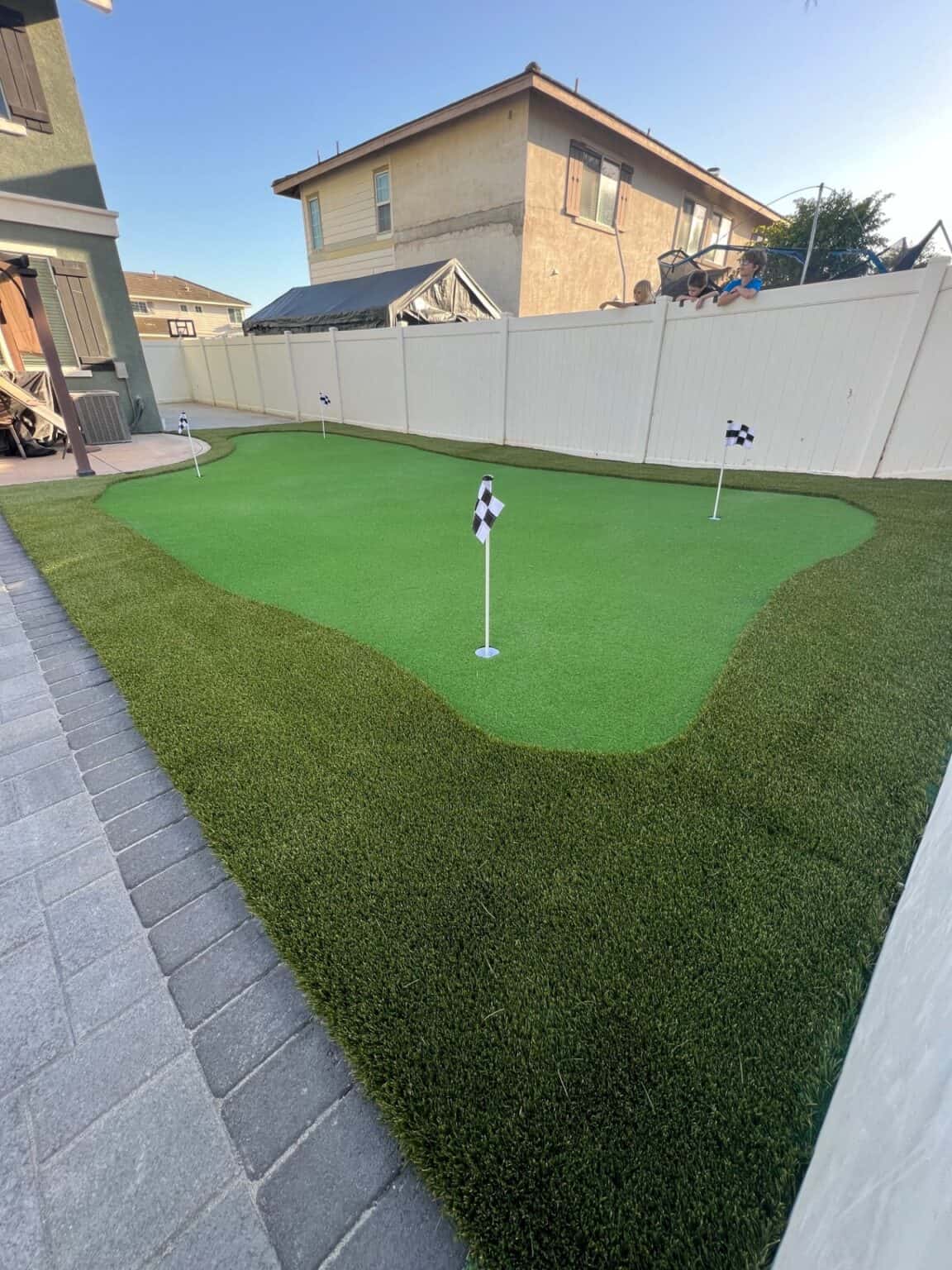 Finished backyard with artificial turf installed by VC Turf