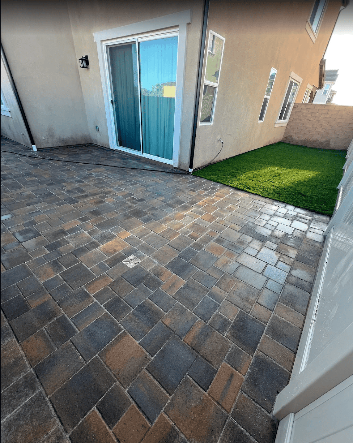 Backyard remodeled with artificial turf and a seating area