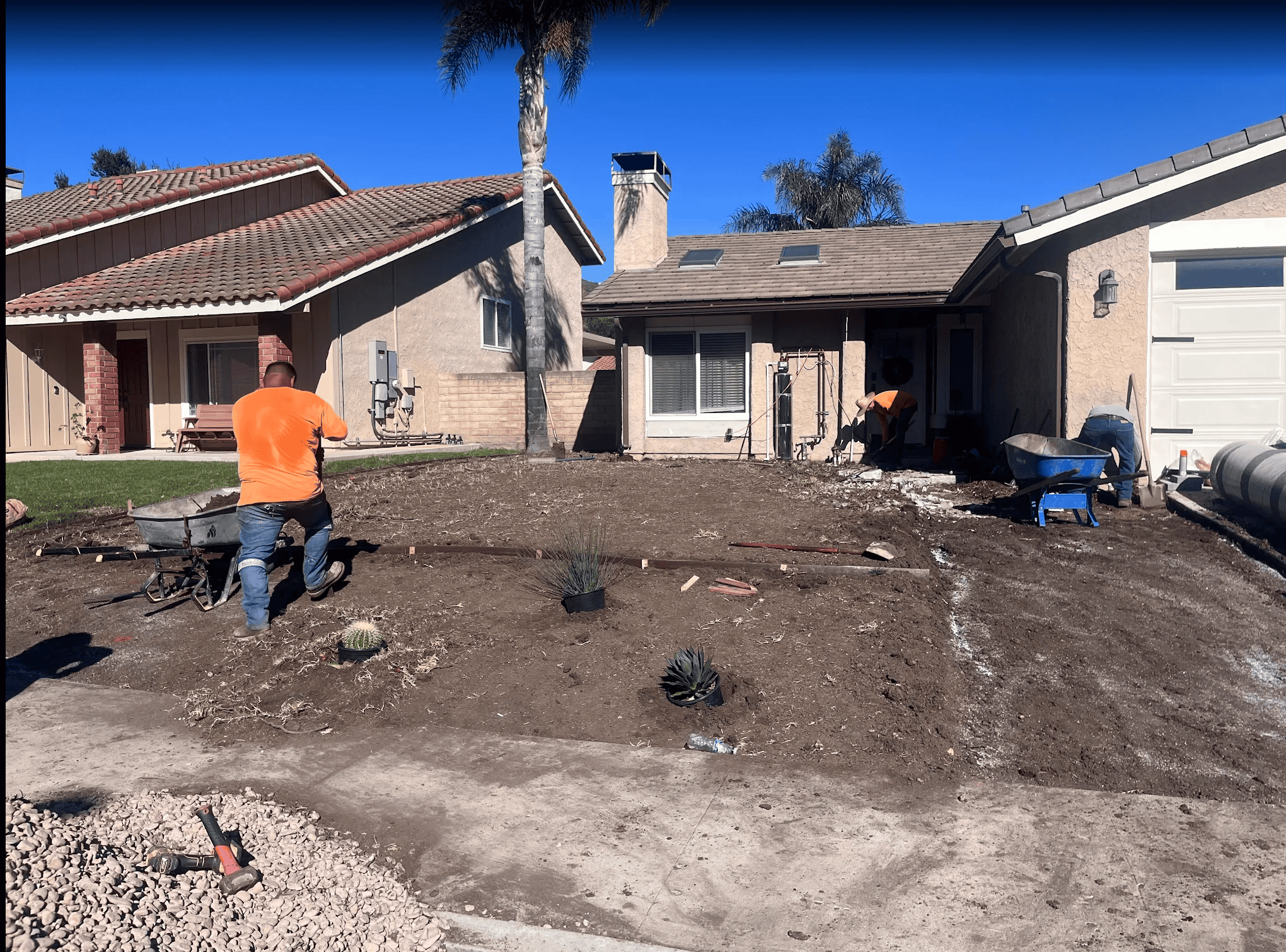 Front yard mid-remodel with the lawn stripped and the base being prepared