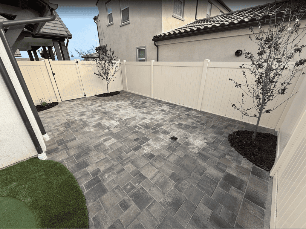 Interlocking pavers set in a herringbone pattern with a contrasting border