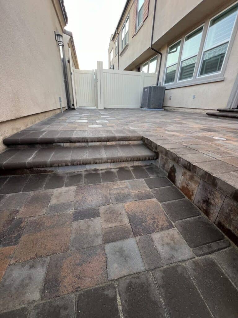 Finished paver surface with tight sand-filled joints and a straight border course
