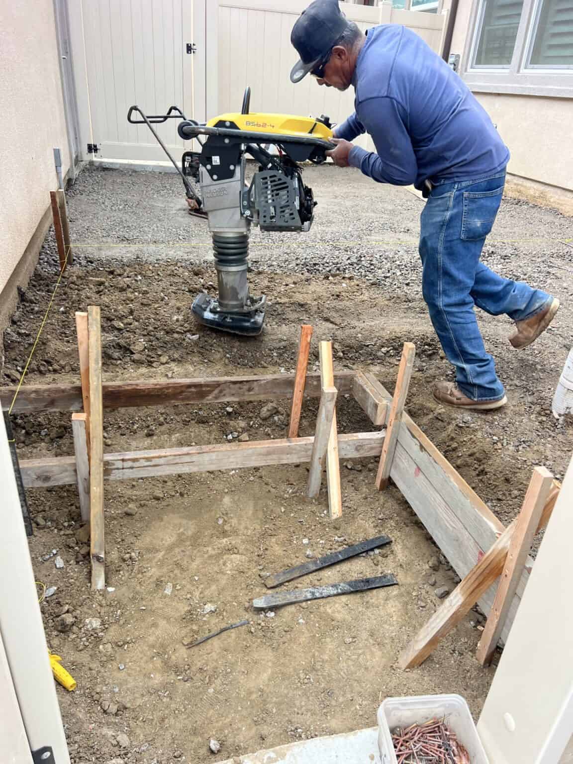 Front yard before paver work, with old surface and bare ground